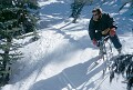 Doug Ritchie hunting for powder. Doug has been riding skibikes a long time, <br />in fact he rode the first skibike up at Lake Louise way back in 1974. <br />Lake Louise, Alberta. April, 2000.