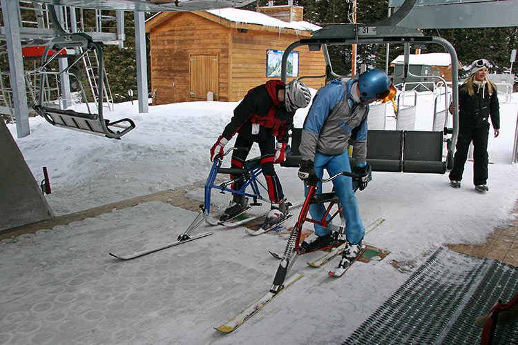 Preparing to load the chairlift. Notice how the skibikes are sitting <br />nicely on the platform between the riders legs...